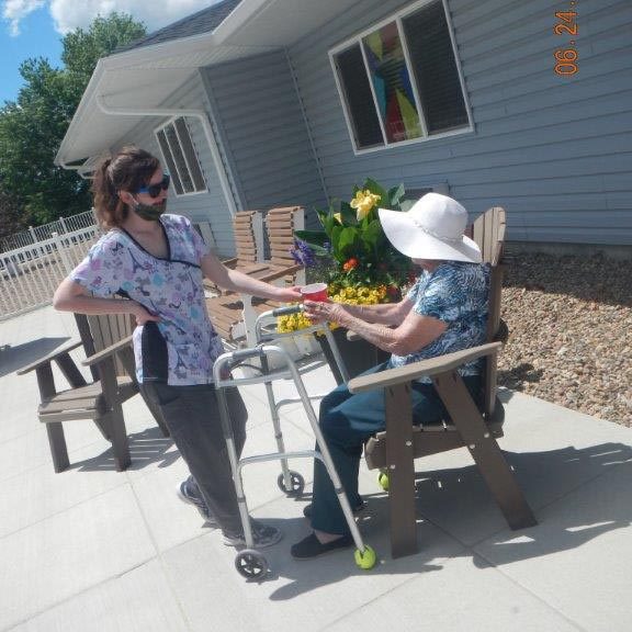 Image of a nurse helping a resident.